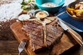 Piece of grilled t-bone steak on wooden board Royalty Free Stock Photo