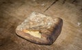 Piece of hardtack bread on wood surface.