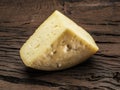 Piece of homemade cheese on the wooden background