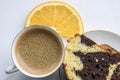 Piece of homemade chocolat-orange cake decorated with orange slice and a cup of espresso coffee on a white background Royalty Free Stock Photo