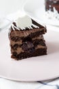 Piece of homemade chocolate cherry cake on a white plate over white wooden background, side view. Close-up Royalty Free Stock Photo