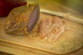 Piece of homemade parma cold cut on wooden board