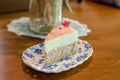 Piece of homemade taro cake in classic plate on table with copy space