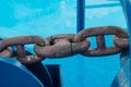 A fragment of a steel ship\'s anchor chain against the background of the ship\'s deck. Royalty Free Stock Photo