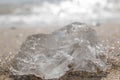 A piece of ice on the beach on a sunny day