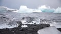 Piece of ice in Iceland, iceberg, black beach sand