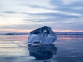 A piece of ice lying on the frozen surface of lake Baikal at dawn Royalty Free Stock Photo