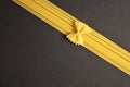 Piece of Italian farfale pasta on spaghetti like ribbon and bow