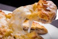 Piece of khachapuri with meat and melted cheese
