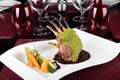 Piece of lamb rack with bone roasted with green herb, bread, sweet potatoes puree, baby vegetables Royalty Free Stock Photo