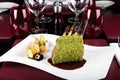 Piece of lamb rack with bone roasted with green herb, bread, sweet potatoes puree, baby vegetables Royalty Free Stock Photo