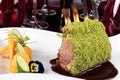 Piece of lamb rack with bone roasted with green herb, bread, sweet potatoes puree, baby vegetables Royalty Free Stock Photo