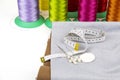 A piece of leatherette with needles and thread. Sewing workshop. Royalty Free Stock Photo