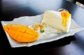 A piece of mango cheese cake on table wooden Royalty Free Stock Photo