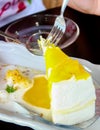 A piece of mango cheese cake on table wooden Royalty Free Stock Photo
