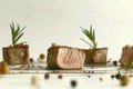 A piece of meat with a sprig of rosemary on top of it Royalty Free Stock Photo