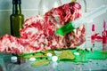 A piece of meat with a syringe with a green substance
