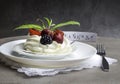 Piece of meringue cake Pavlova with whipped cream and fresh strawberry, blackberry, cherry, currant, mint Royalty Free Stock Photo