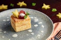 Piece of millefeuille cake on wooden background