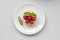 A piece of mini fresh raspberries tart
