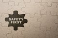 Piece of missing jigsaw puzzle with \'safety first\' text Royalty Free Stock Photo