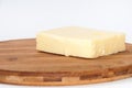 Piece of mozzarella cheese on a kitchen wooden board Royalty Free Stock Photo