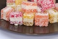 Piece multicolored layered confectionery jelly marmalade sprinkled with flaked coconut
