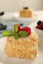 Piece of Napoleon cake with raspberries on plate, closeup Royalty Free Stock Photo