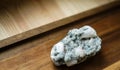 Piece of natural stilbite on the wooden background