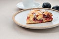 Piece of The New York Times Famous Plum Torte, pie on plate on beige table. Traditional fruit cake. Royalty Free Stock Photo