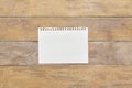 Piece of note pad paperon wooden desk. Top view. Royalty Free Stock Photo