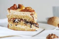 A piece of nut cake with caramel lies on a saucer on the table. Royalty Free Stock Photo