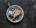 A piece of oatmeal chocolate cake with Greek yogurt and blueberries on a vintage plate on a dark background Royalty Free Stock Photo