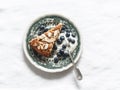 A piece of oatmeal chocolate cake with greek yogurt and blueberries on a vintage plate on a light background Royalty Free Stock Photo