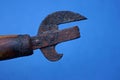 Piece of old rusty can opener with brown wooden handle Royalty Free Stock Photo