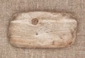 Piece of old wood on burlap background Royalty Free Stock Photo