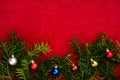 Piece of paper for Christmas wishes on a red background with branches of Christmas tree and Christmas balls Royalty Free Stock Photo