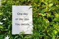 Piece of paper with inspirations quotes - One day or day one. You Decide