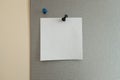 A piece of paper pinned to a gray board. office atmosphere