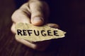 Piece of paper with the word refugee