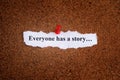 A piece of paper with the words Everyone has a story written on it that is pinned to a cork board Royalty Free Stock Photo