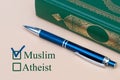 On a piece of paper are written Muslim and Atheist with a choice. religion Muslim or unbeliever checkbox on white paper with pen.