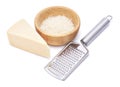 Piece of parmesan cheese, knife and grated cheese in wooden bowl isolated on white background Royalty Free Stock Photo