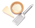 Piece of parmesan cheese, knife and grated cheese in wooden bowl isolated on white background Royalty Free Stock Photo