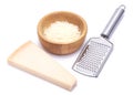 Piece of parmesan cheese, knife and grated cheese in wooden bowl isolated on white background Royalty Free Stock Photo