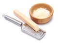 Piece of parmesan cheese, knife and grated cheese in wooden bowl isolated on white background Royalty Free Stock Photo