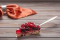 Piece of pie with berries: raspberries, currants, strawberries on the shovel on wooden background, in the background Royalty Free Stock Photo
