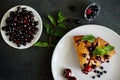 Piece of pie with blueberries, rasberry,cherries and mint for dessert on a white plate, napkin. Pieces of delicious homemade cake Royalty Free Stock Photo