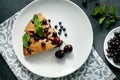 Piece of pie with blueberries, rasberry,cherries and mint for dessert on a white plate, napkin. Pieces of delicious homemade cake. Royalty Free Stock Photo