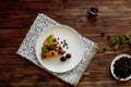 Piece of pie with blueberries, rasberry,cherries and mint for dessert on a white plate, napkin. Pieces of delicious homemade cake. Royalty Free Stock Photo